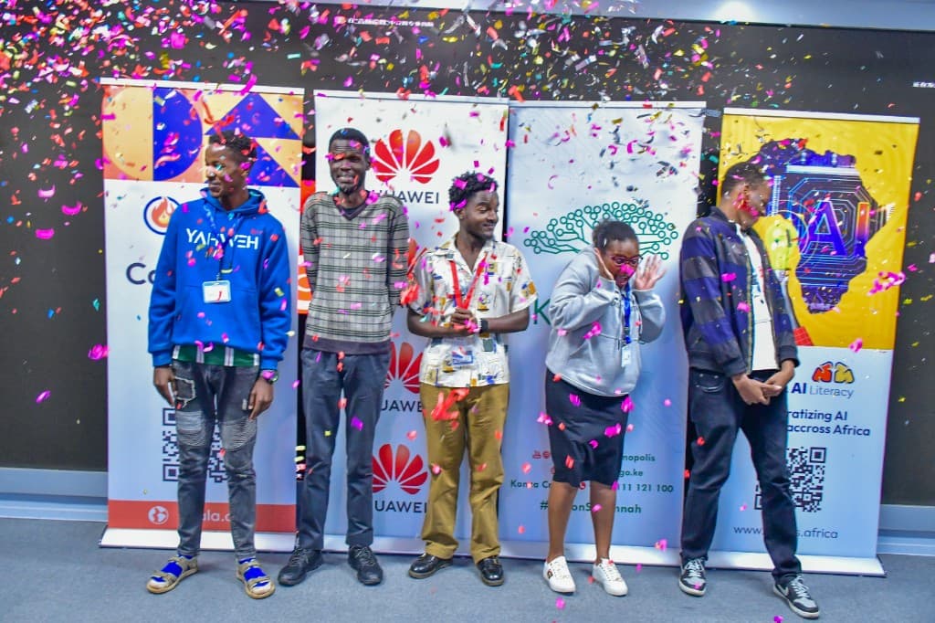 Africa AI Literacy graduates celebrating with confetti under AI Literacy banners